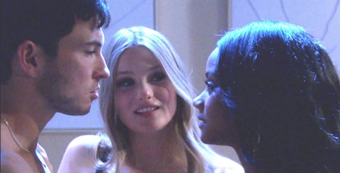 Three people leaning close together in an intimate threesome moment
